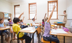 Children With Raised Hands In Classroom 1