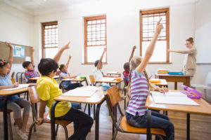 Children With Raised Hands In Classroom 1