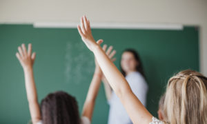 Children In Classroom With Raised Hands 2