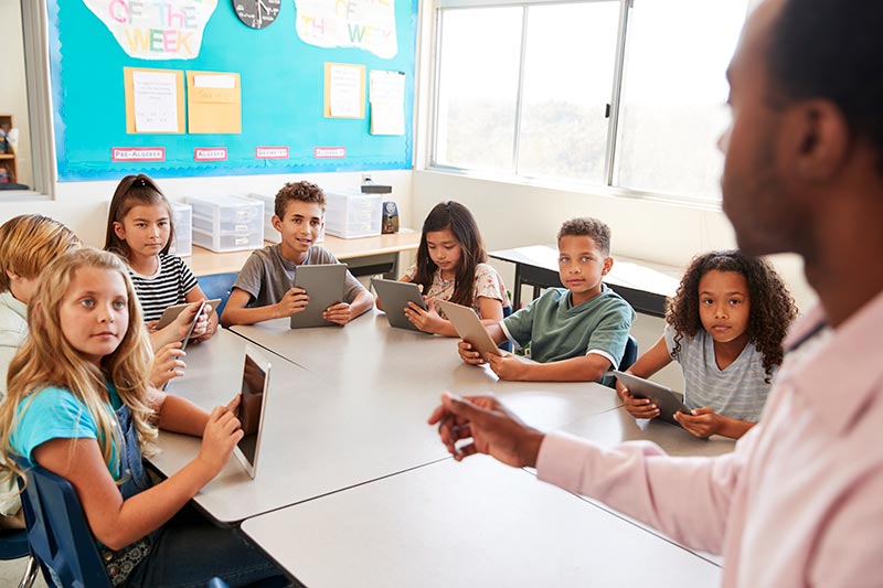 Children In Classroom With iPads